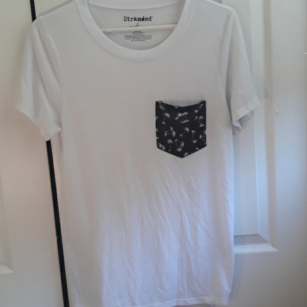 White t-shirt, front pocket black with palm trees